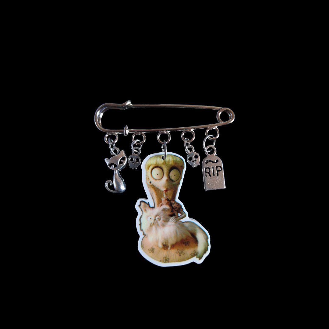 Broche con dijes La Chica Rara
